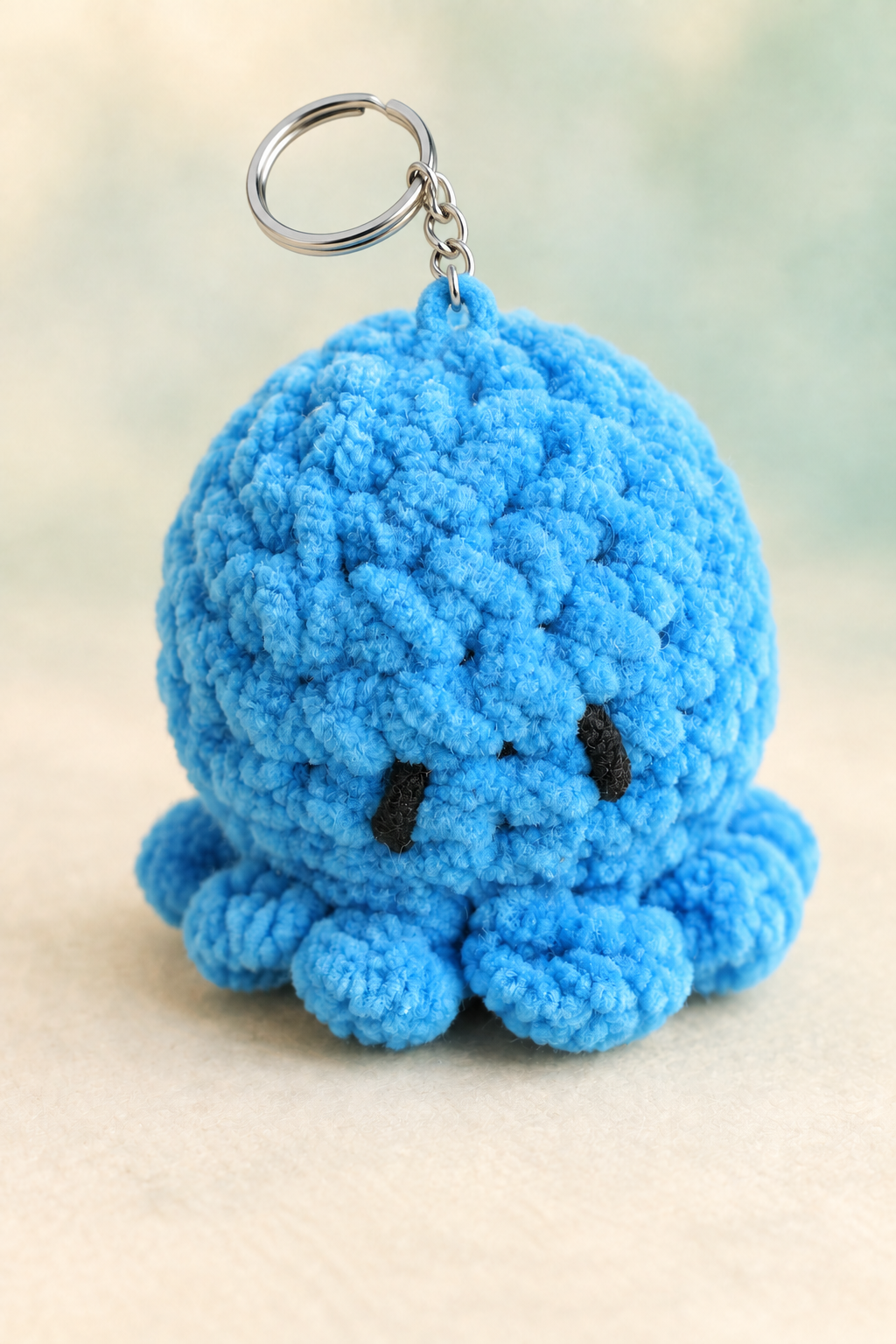 Blue crocheted octopus keychain, alternate portrait product image